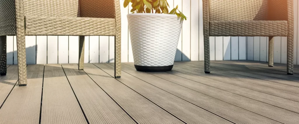 a modern patio with composite decking and wicker furniture