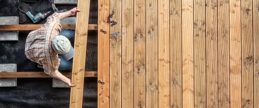 a top down view of a deck builder constructing a wood deck