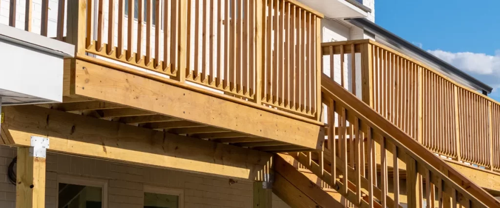 a wooden deck railing system built from pressure-treated lumber