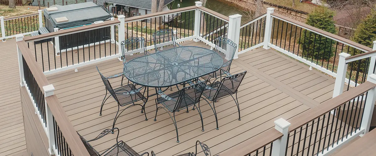 Large composite entertaining deck with black aluminum railing and outdoor dining space