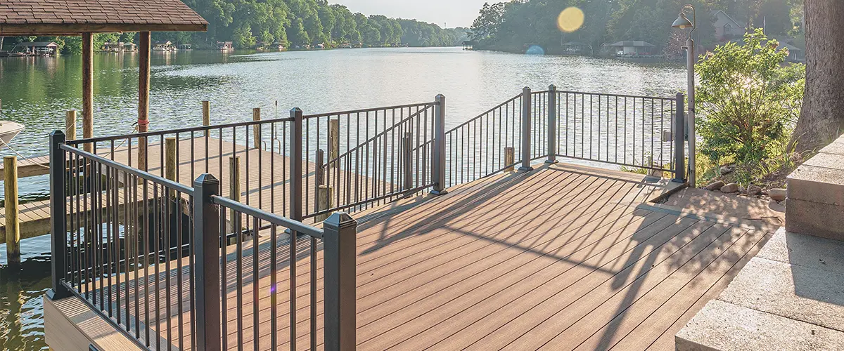 Waterfront composite deck with aluminum railing and private dock lake views